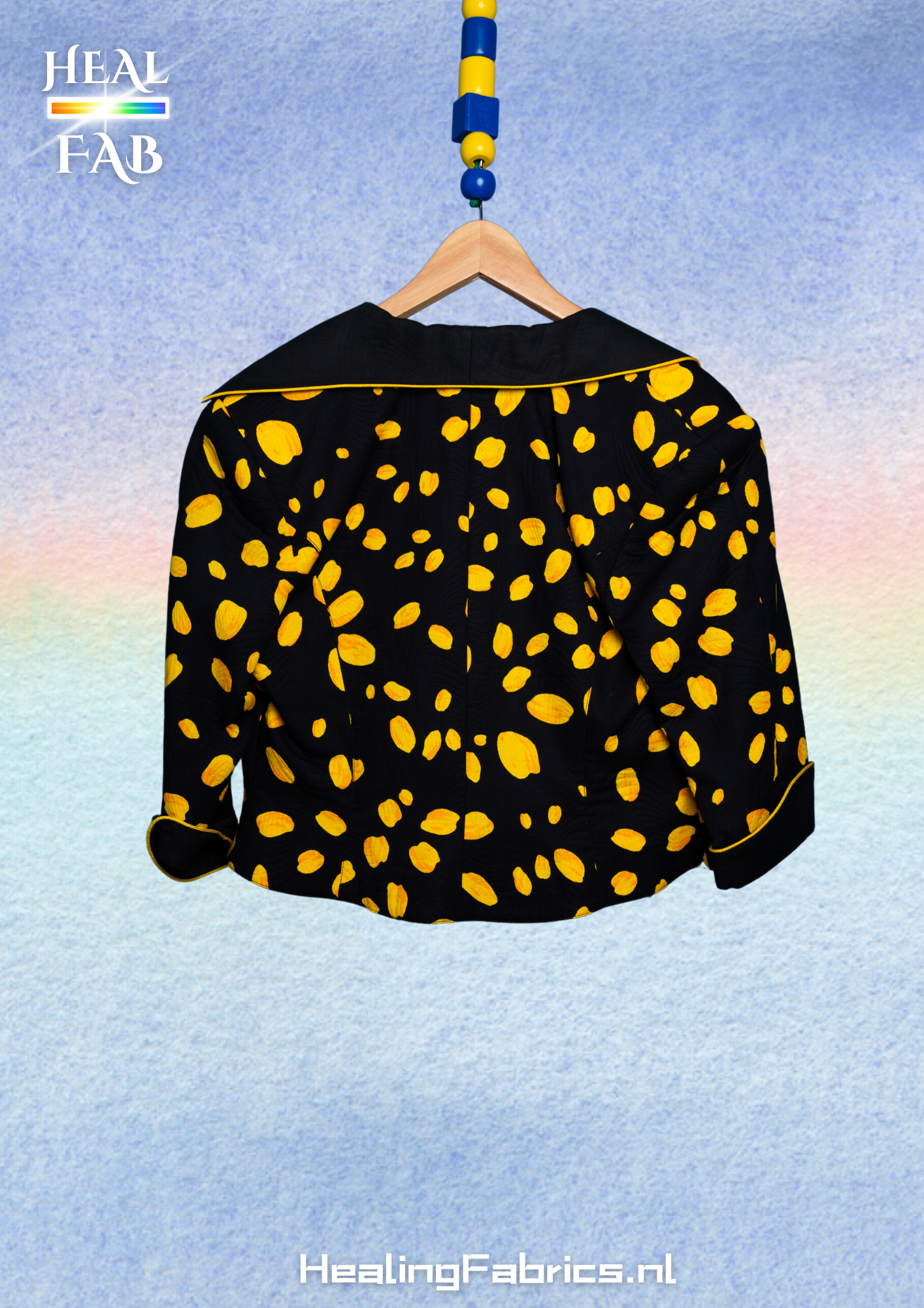 The reversed polka-cheese blazer with asymmetrical collar in black & yellow tint