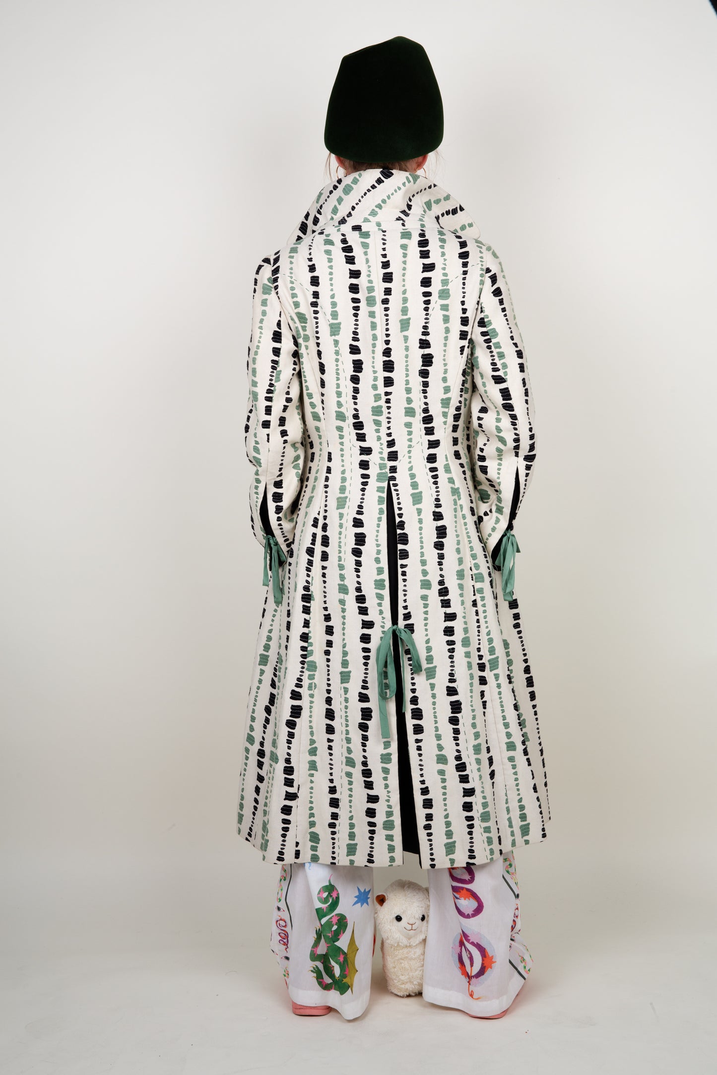 The artist coat in white, green and black