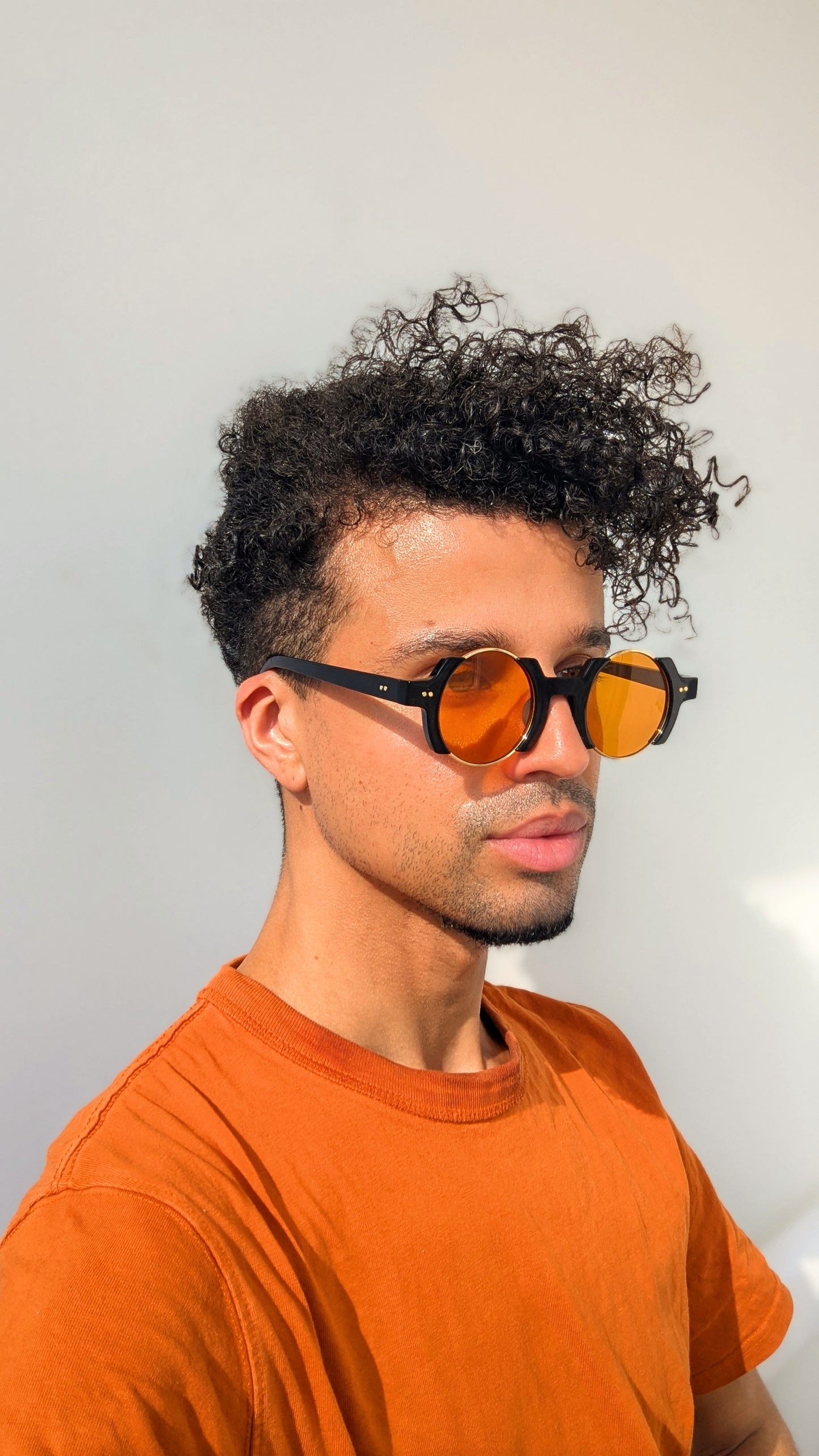 The Soulful Signature sunglasses with circular shaped orange vision & gold details